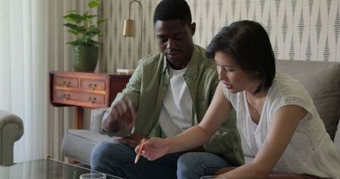 Multicultural friends enjoying conversation at home