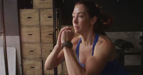 Caucasian Woman Cross Training in Gym Performing Box Jumps