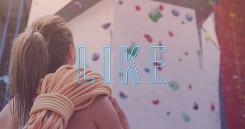Motivated woman preparing to climb indoor rock wall with 'like' overlay