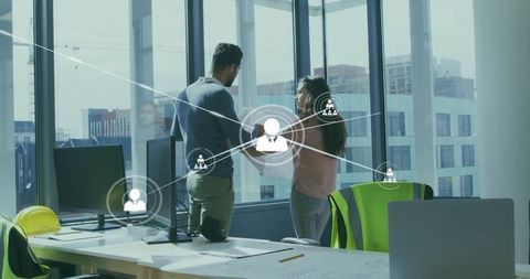 Engineers Discussing Architectural Plans in Modern Office with Digital Overlay