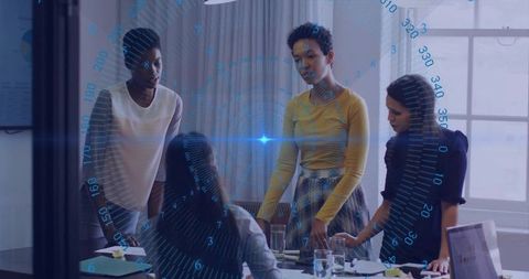 Businesswomen Analyzing Holographic Data in Modern Workspace