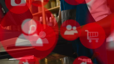 Technology Icons Overlaying Person Using Computer in Business Environment