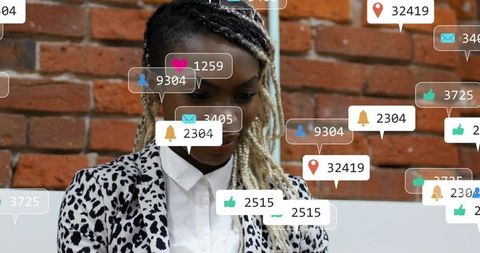 Woman checking social notifications with floating analytics overlays in coworking brick office