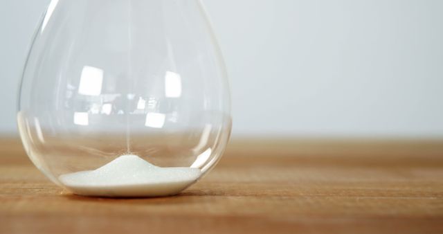 Transparent Hourglass with Flowing Sand on Wooden Surface - Download Free Stock Images Pikwizard.com