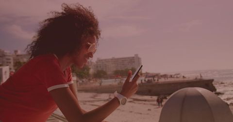 Happy Young Woman Enjoys Beach View While Texting
