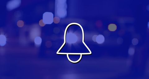 Bell Icon on Night Cityscape with Blurred Lights