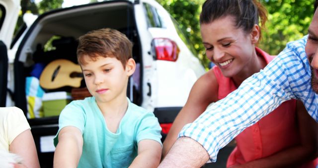 Family Bonding During Outdoor Trip, Smiling and Unpacking - Download Free Stock Images Pikwizard.com