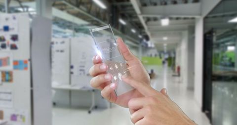Person Interacting with Futuristic Transparent Smartphone in Modern Office - Download Free Stock Images Pikwizard.com