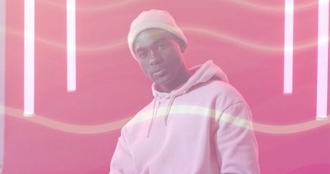 Stylish man in pink hoodie with neon urban vibes