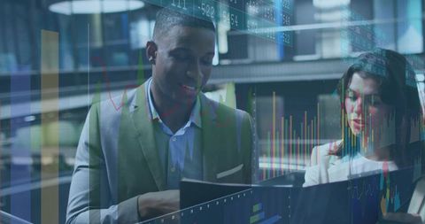 Modern Office Team Analyzing Financial Data with Dynamic Graphics