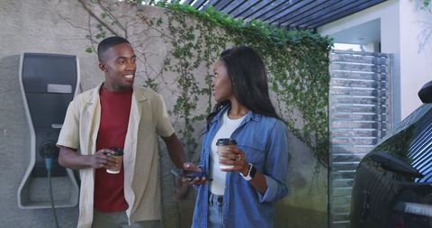 Couple Engaging Near Electric Vehicle Charger at Home