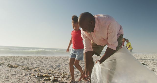 Family Cleaning Beach on Sunny Day - Download Free Stock Images Pikwizard.com