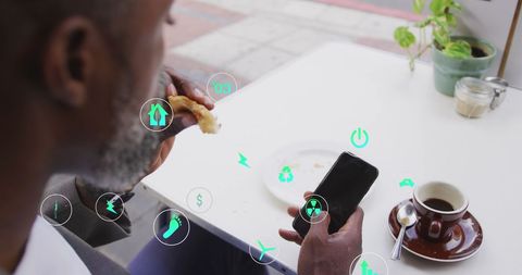 Urban Man Engaging with Mobile Technology during Coffee Break