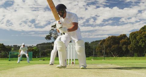 Focused Cricket Batsman Ready to Hit on Sunlit Field - Download Free Stock Images Pikwizard.com