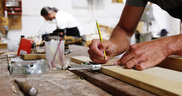 Carpenter Measuring Wood with Pencil and Square in Workshop - Download Free Stock Images Pikwizard.com