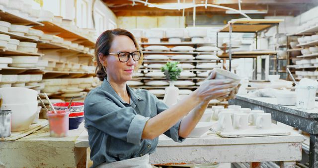 Confident Potter Inspecting Clay Pot in Studio - Download Free Stock Images Pikwizard.com