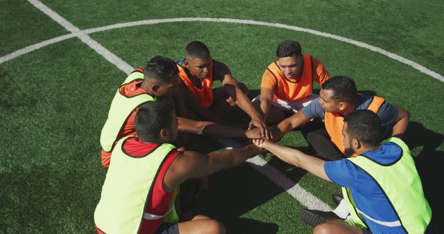 Diverse male football players training and teaming up on outdoor pitch - Download Free Stock Photos Pikwizard.com