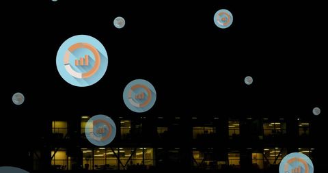Digital Graph Icons Overlaying Modern Office Building at Night - Download Free Stock Images Pikwizard.com