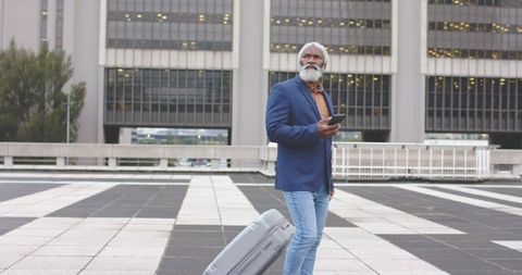 Senior african american traveler waiting with rolling suitcase on urban rooftop plaza