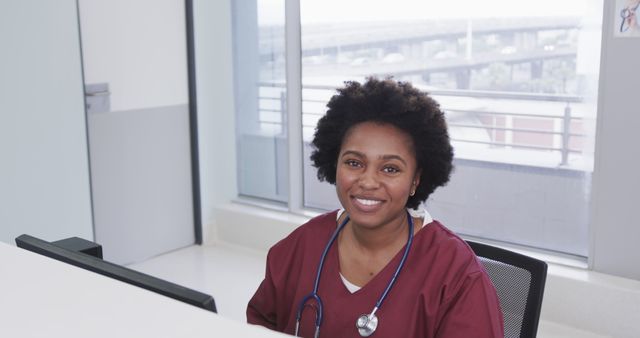Portrait of happy african american female doctor using computer in hospital, slow motion - Download Free Stock Photos Pikwizard.com