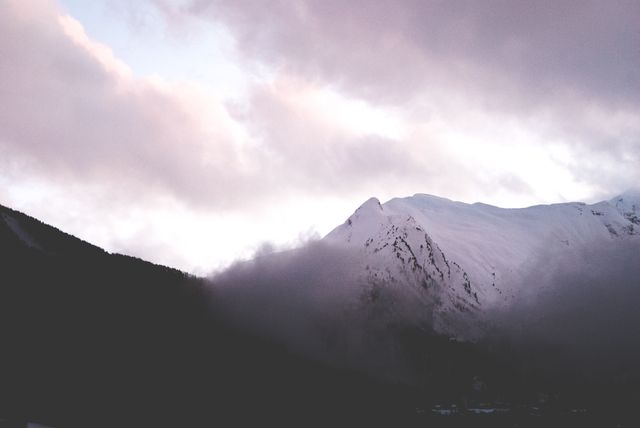 Misty sunrise over snowy mountain peak - Download Free Stock Photos Pikwizard.com