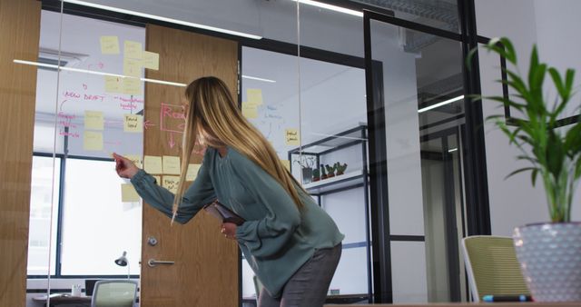 Businesswoman Brainstorming and Writing on Office Glass Wall - Download Free Stock Images Pikwizard.com