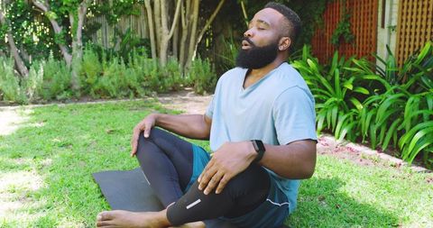 African american man practicing spinal twist outdoors in serenity