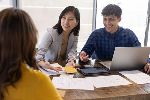 Diverse Team Collaborating in Urban Office with Sketches and Technology
