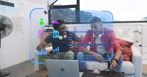 Recording podcast cohosts collaborating on couch with ar data overlay and audio equipment