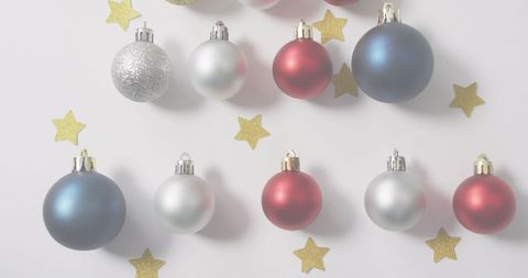 Colorful Christmas Ornaments and Golden Stars on White Background