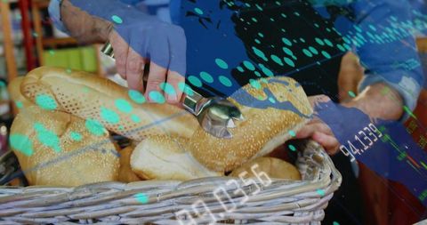 Bakery Worker Handling Fresh Bagels with Economic Indicator Overlay