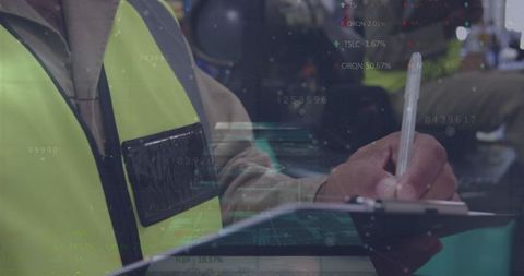 Warehouse Workers Analyzing Logistics Data with Technology Graphics