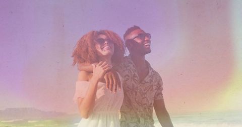 Smiling Couple Embracing at Sunset Beach