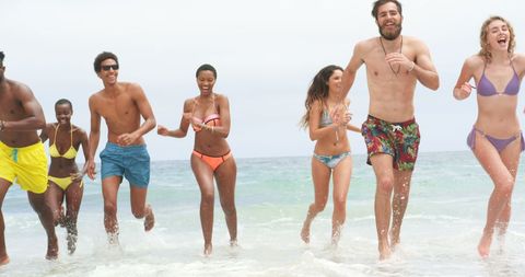Diverse Group of Friends Enjoying Beach Fun in Swimwear