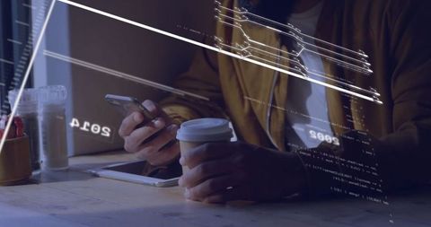 Man Engaging with Technology During Coffee Break in Cafe