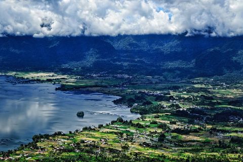 Aerial View of Serene Landscape with Lush Mountains and Tranquil Lake