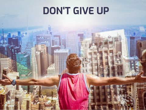 Inspirational male figure overlooking cityscape triumph