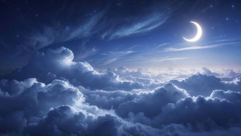 Crescent moon over serene cloudscape with starry night sky
