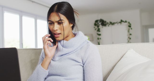 Concerned Woman Talking on Mobile Phone and Using Laptop - Download Free Stock Images Pikwizard.com