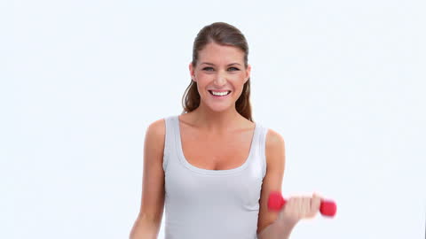 Woman Smiling While Exercising with Dumbbells