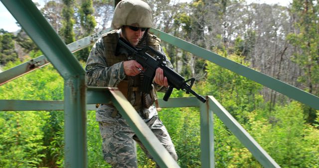 Military soldier taking part in a training exercise in an outdoor location. Suitable for use in articles about military training, tactical operations, armed forces readiness, and defense techniques.