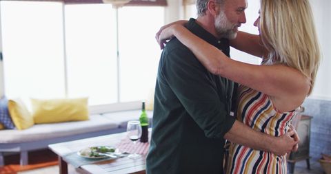 Mature Couple Dancing in Sunlit Living Room