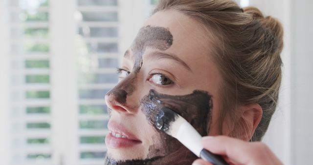 Woman Applying Black Face Mask at Home with Brush - Download Free Stock Images Pikwizard.com