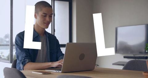 Young Professional Working on Laptop in Modern Loft Space