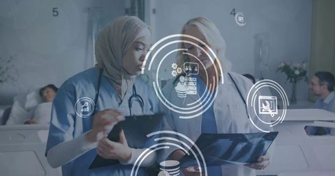 Female clinicians reviewing x-ray and tablet with digital hud overlay in hospital ward