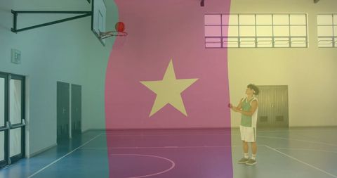 Basketball Player Shooting in Gym Behind Cameroon Flag