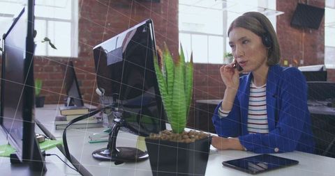 Asian Businesswoman on Headset Working in Modern Open-Plan Office