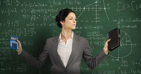 Confident Businesswoman Balancing Math with Technology