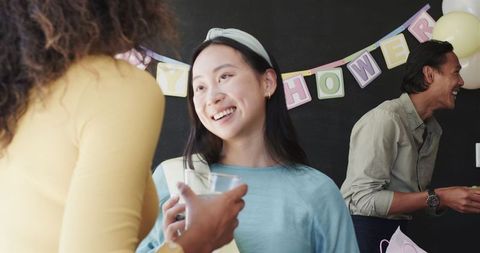 Colleagues enjoy baby shower celebration in office