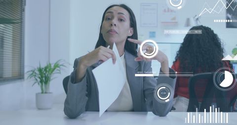 Businesswoman Analyzing Data with Digital Interface Display